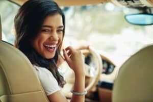 Woman enjoying her new car